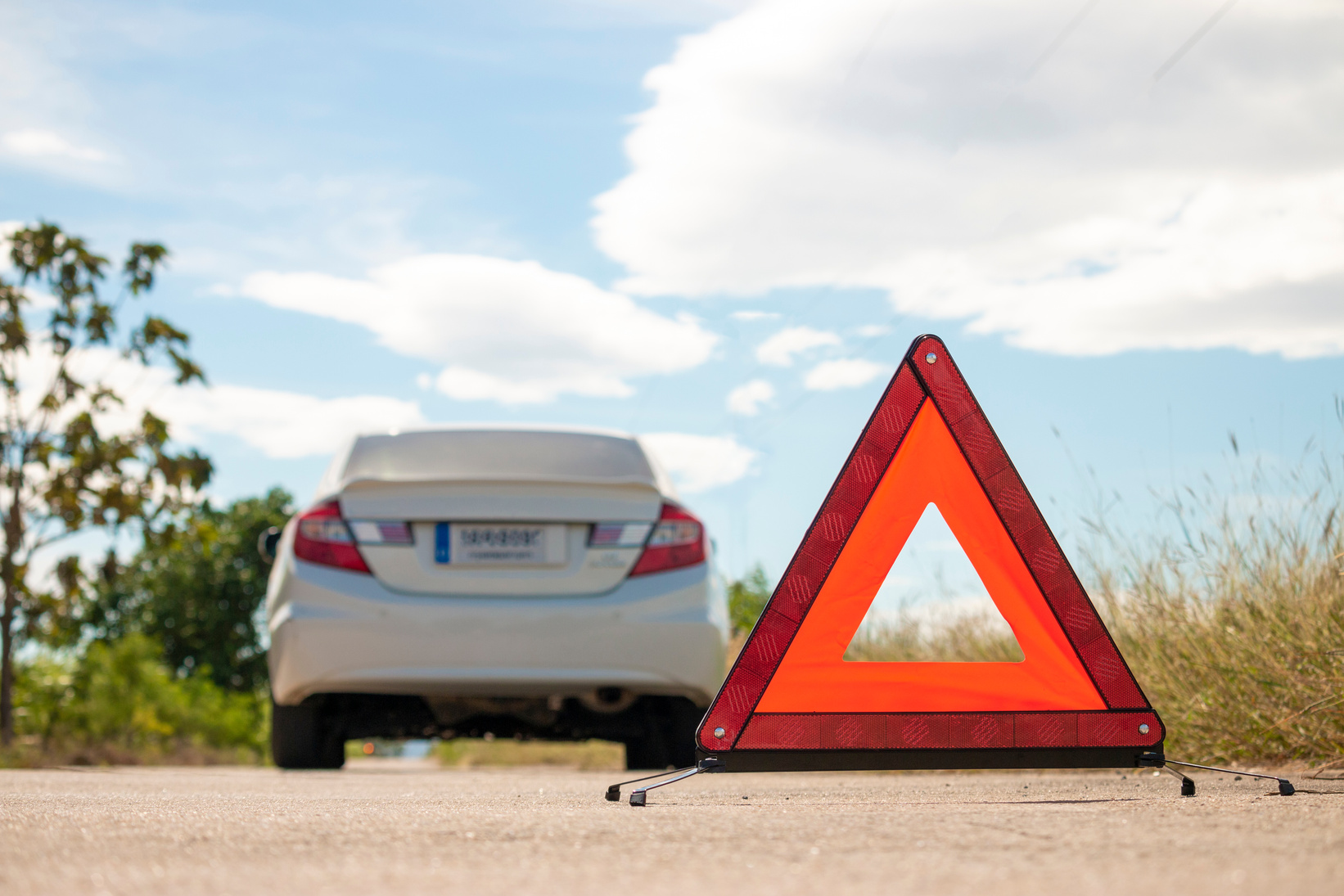 Emergency Stop Sign and Broken Car on Road